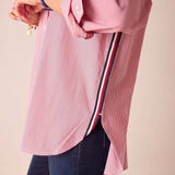 Cardinal red and white pinstripe button-up shirt featuring oversized cuffs and a contrasting striped trim detail.