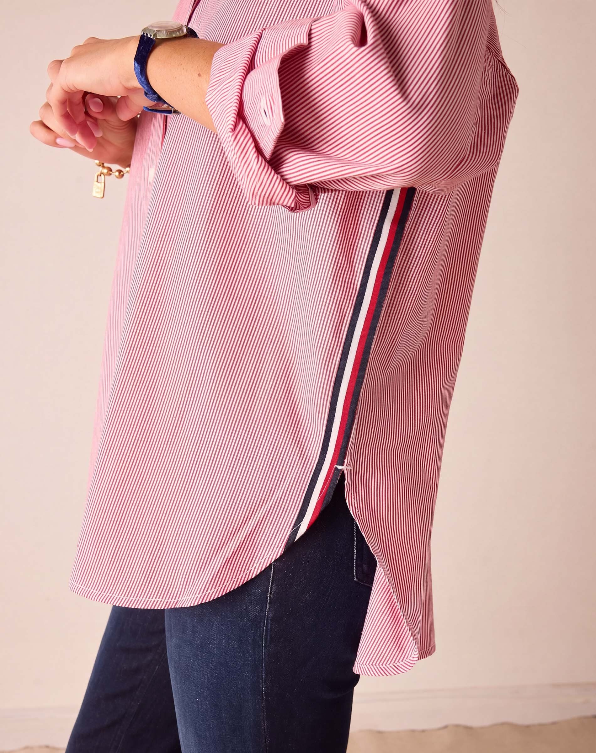 Cardinal red and white pinstripe button-up shirt featuring oversized cuffs and a contrasting striped trim detail.