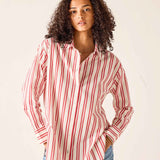 Woman wearing a red and white striped shirt against a plain background