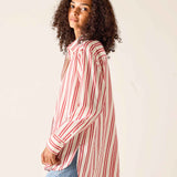 Person wearing a red and white striped shirt against a plain background
