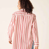 Person wearing a red and white striped shirt against a plain background
