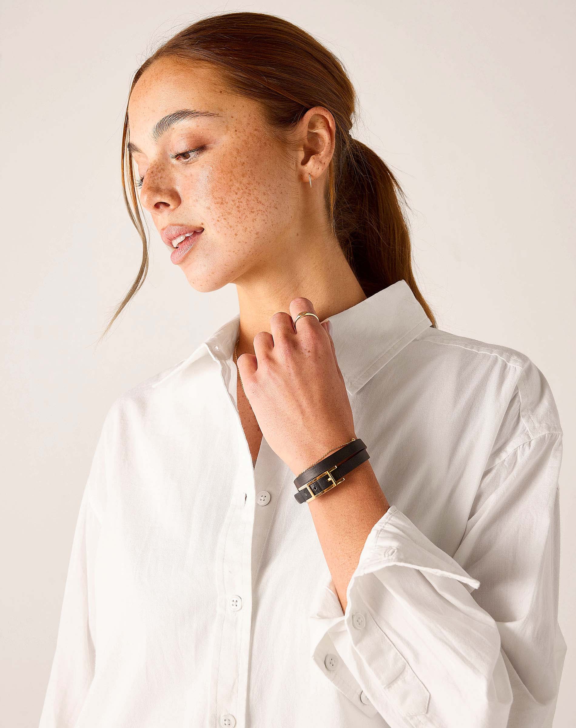 White button-up linen shirt with ruffled cuffs.