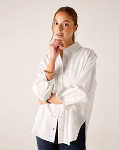 White relaxed-fit button-up linen shirt with rolled sleeves and side slits