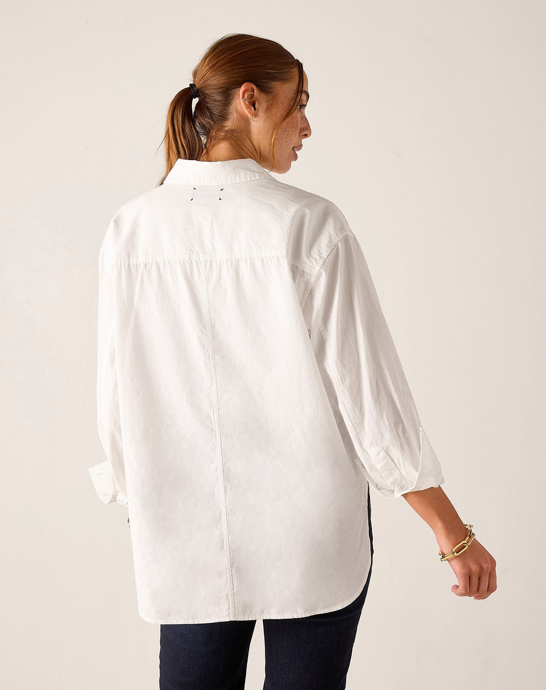 White oversized button-up linen shirt with gathered sleeve details