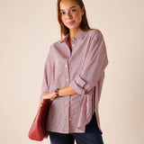 Women's travel-friendly cardinal pinstripe button-down shirt with long sleeves and a leather bag.