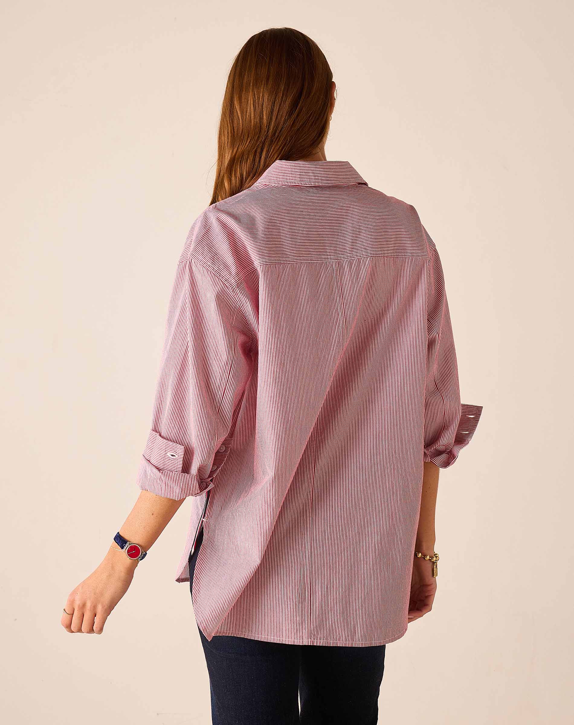 Back view of the pink and white pinstripe long-sleeve shirt with rolled sleeves.