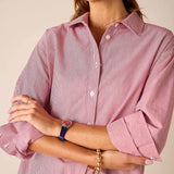 Cardinal red and white pinstripe button-down shirt with rolled sleeves.