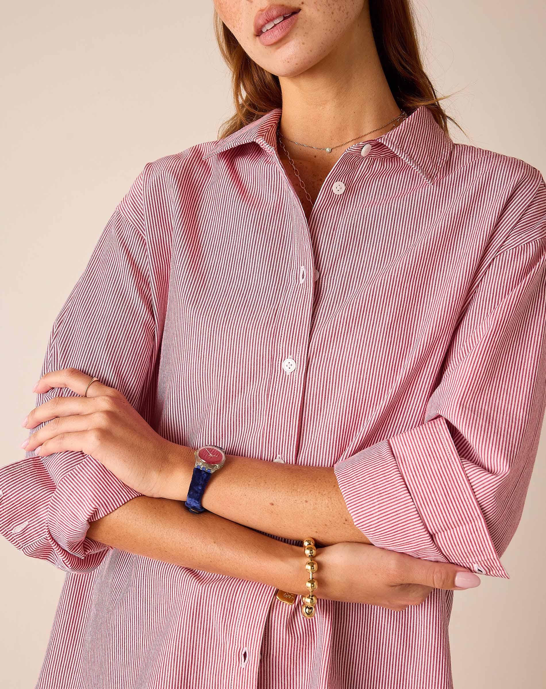 Cardinal red and white pinstripe button-down shirt with rolled sleeves.