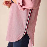 Side view of a cardinal red pinstripe long-sleeve shirt featuring a unique side trim detail.