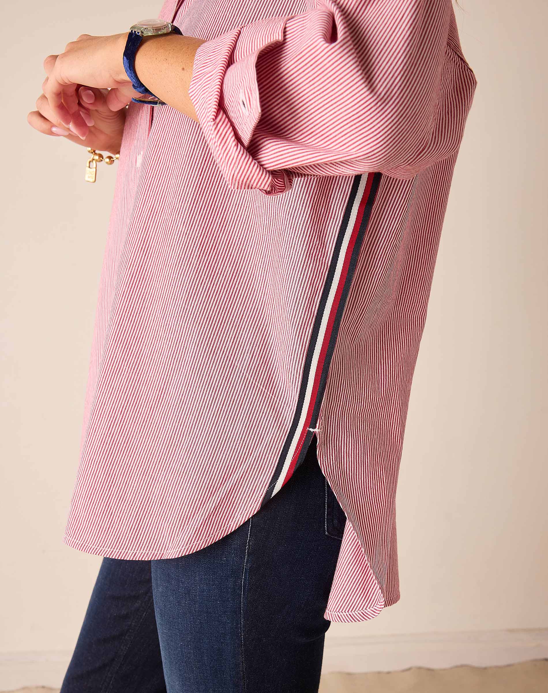 Side view of a cardinal red pinstripe long-sleeve shirt featuring a unique side trim detail.