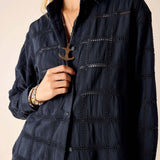Navy blue textured shirt worn by a person on a beige background