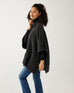 profile of woman wearing mersea cambridge collar poncho in black