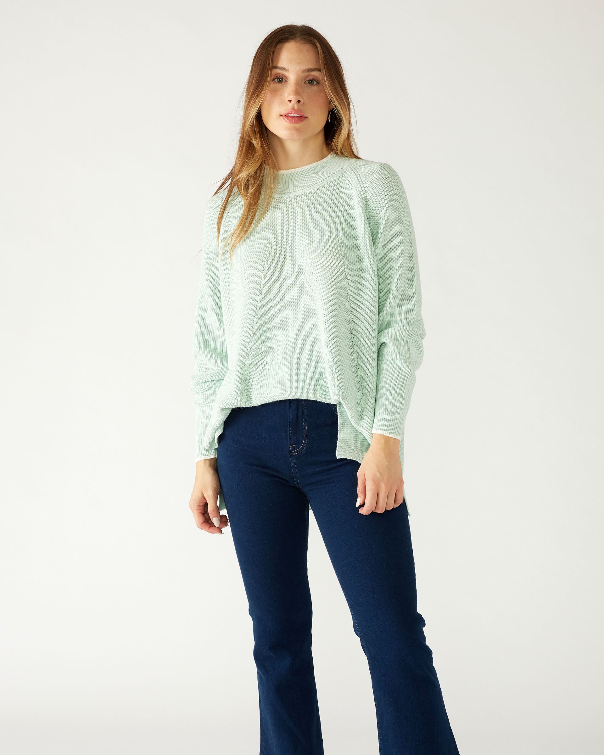 woman wearing mersea camden mockneck sweater in caribbean sea green