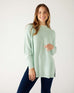 woman wearing mersea camden mockneck sweater in caribbean sea green