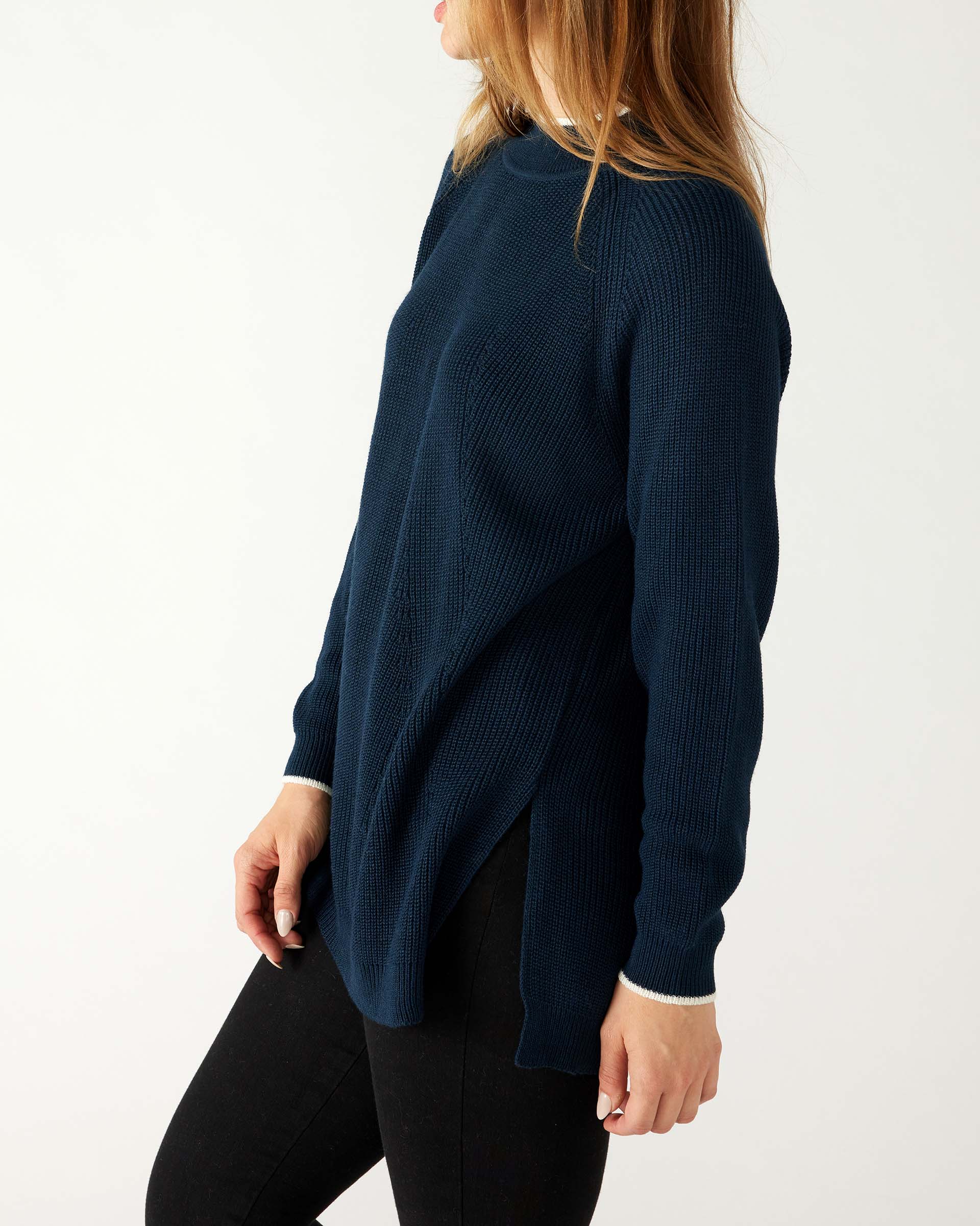 profile of woman wearing mersea camden mockneck sweater in navy and sea salt trim