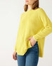 woman wearing mersea camden mockneck sweater in sunbeam yellow