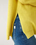 side view of woman wearing mersea camden mockneck sweater in sunbeam yellow