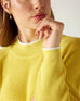 closeup of collar on woman wearing mersea camden mockneck sweater in sunbeam yellow