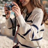 Cream and navy striped knit sweater with a textured ribbed finish.