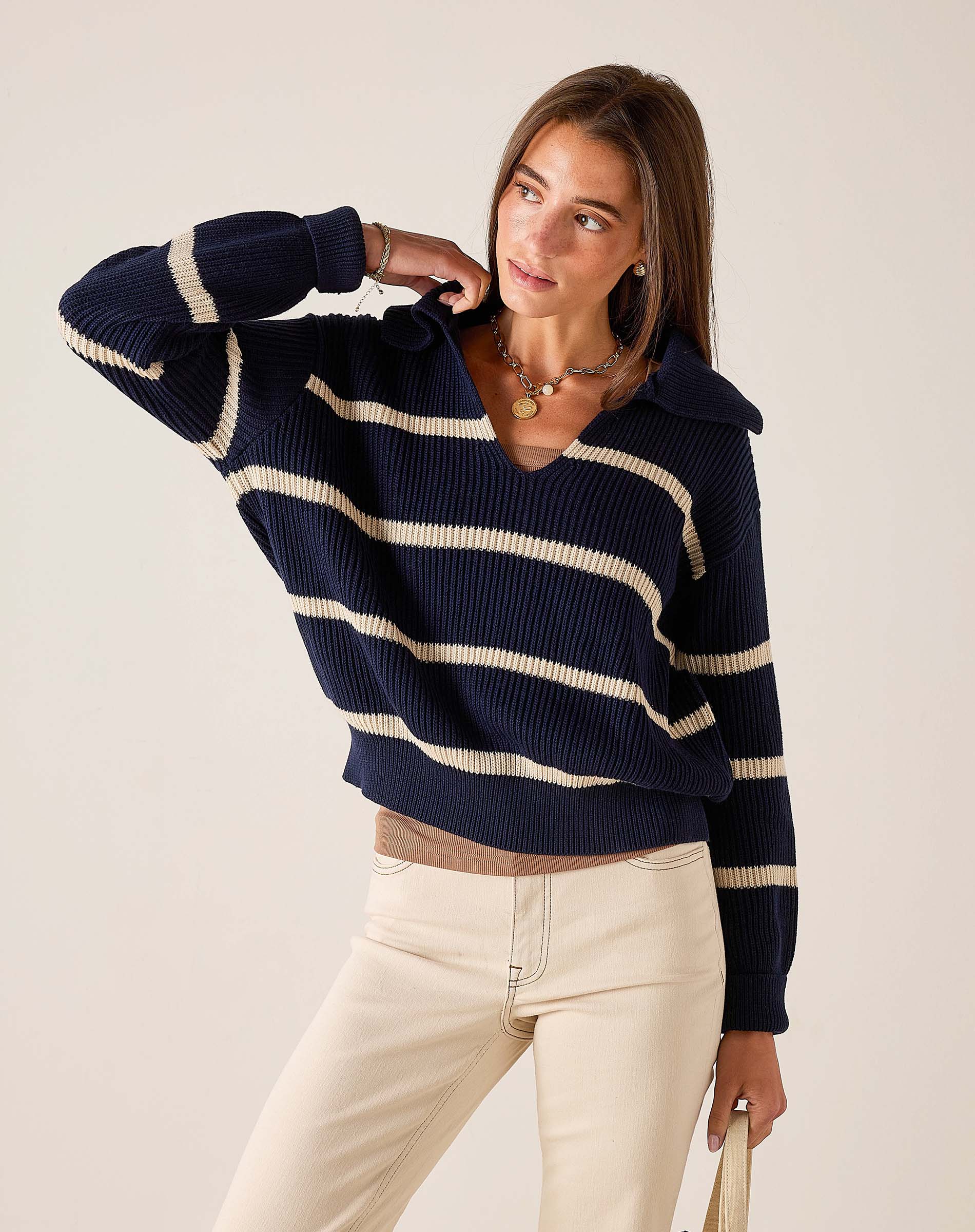 Navy and cream striped ribbed knit sweater with a boat neck and wide sleeves.
