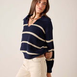 Navy and cream striped knit sweater with a boat neck and long sleeves.