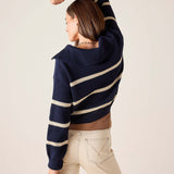 Side view of women's travel-friendly navy and cream striped knit sweater.