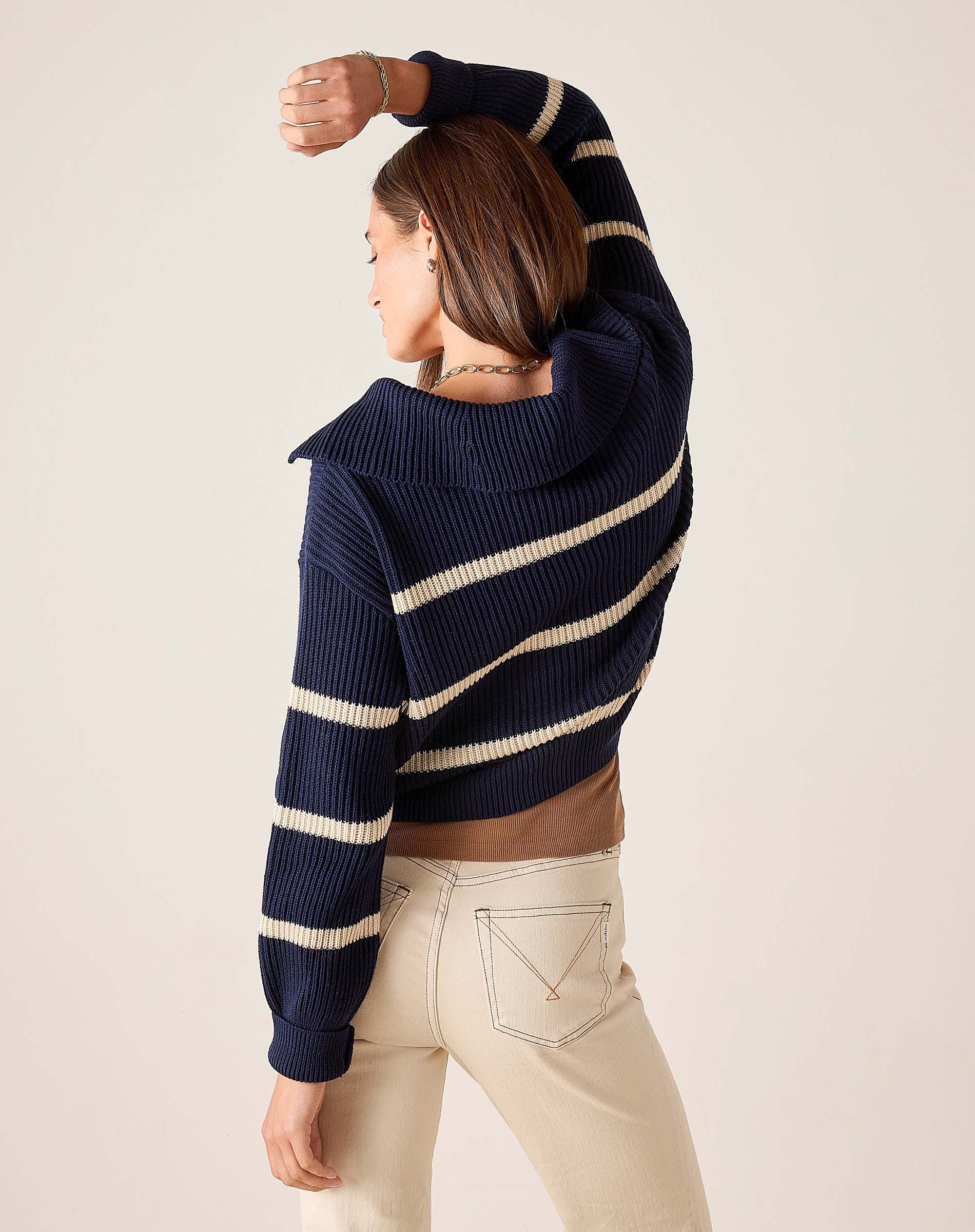 Side view of women's travel-friendly navy and cream striped knit sweater.