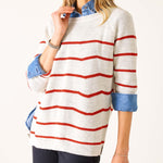 Person wearing a white sweater with red stripes on a white background