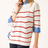 Person wearing a white sweater with red stripes on a white background