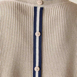 Detail of the desert palm color knit vest with vertical stripes and button closure.