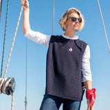Navy blue knit vest over a white long-sleeve shirt