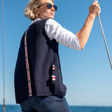 Side view of the navy knit vest with red and white stripe detail.