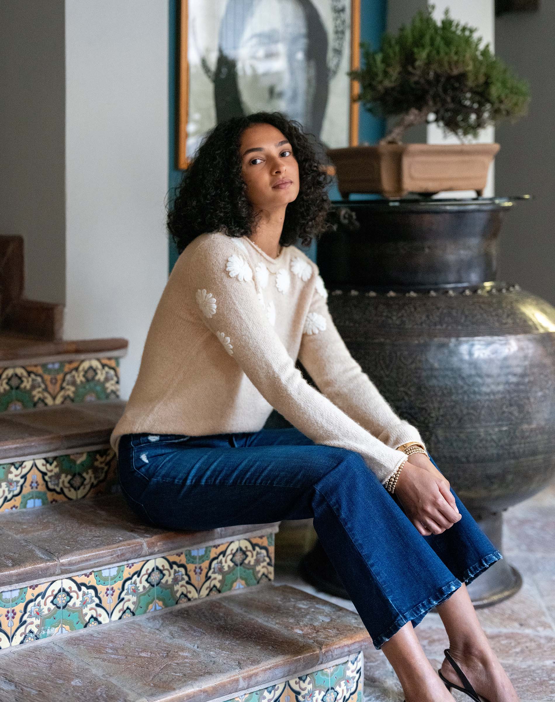 Women's travel-friendly beige and ivory camellia embroidered cashmere sweater with long sleeves.