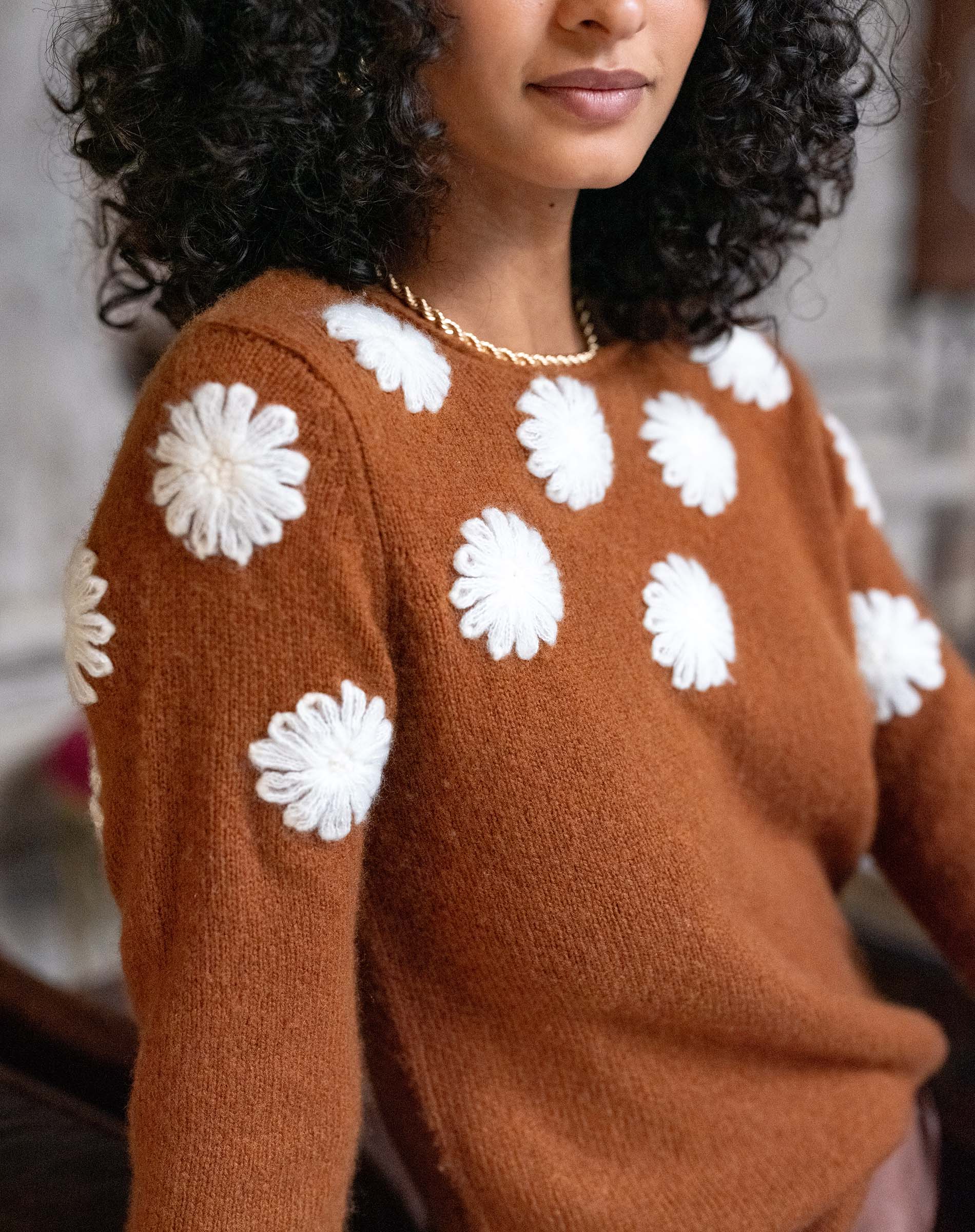 Cinder brown cashmere sweater featuring white camellia flower embroidery.
