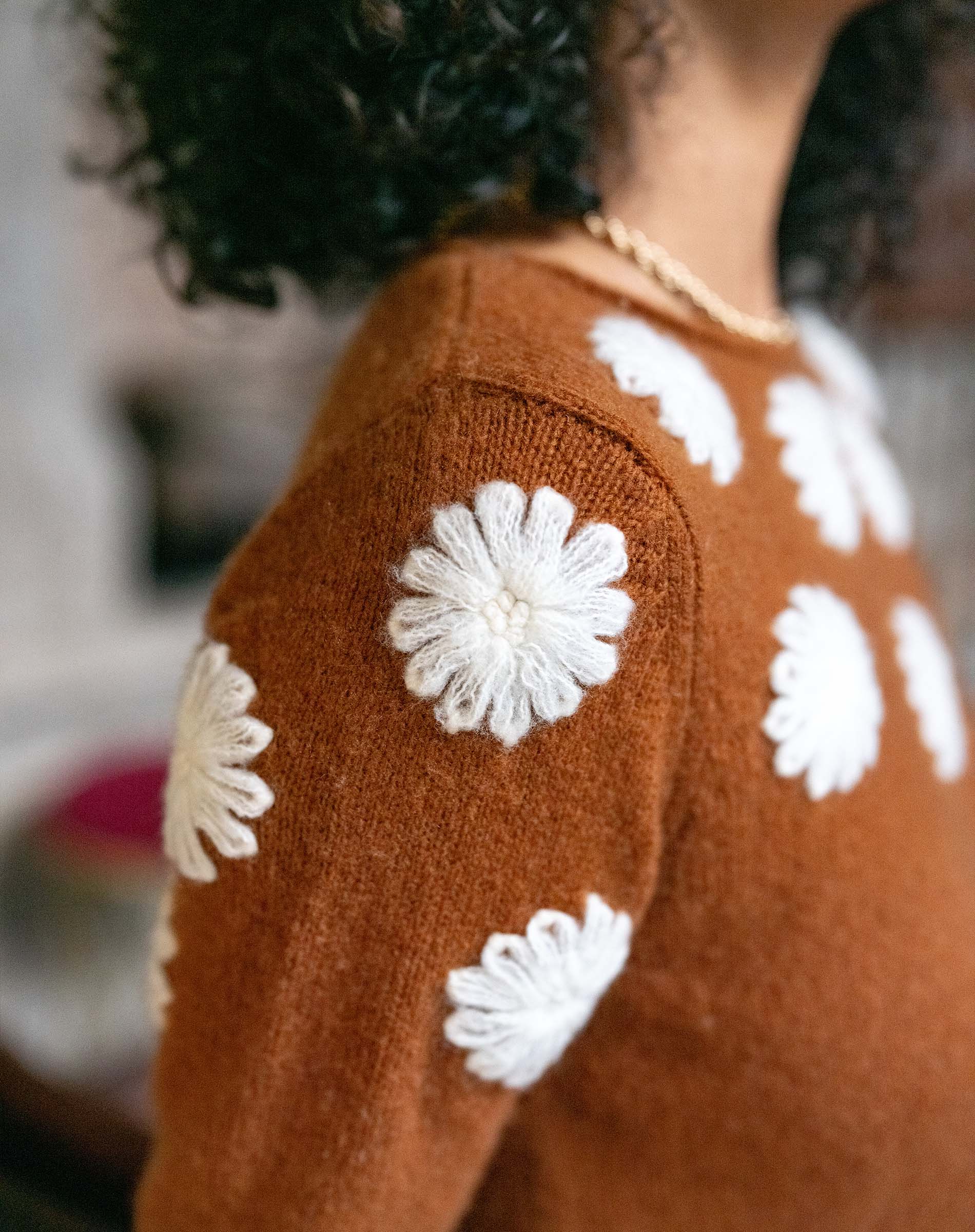 Cinder knit sweater featuring ivory camellia floral embroidery.