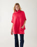 woman wearing mersea cape poncho sweater in hibiscus red