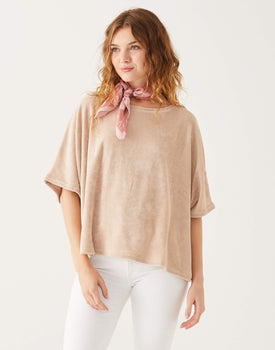 female wearing beige terry slouch tee with dolman sleeves on a white background