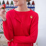 Chili red ribbed cardigan with a ruffled texture and buttoned front.