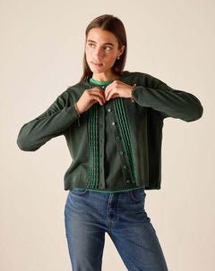 Ladies' travel-ready pine green knit cardigan with ruffled trim and button front.