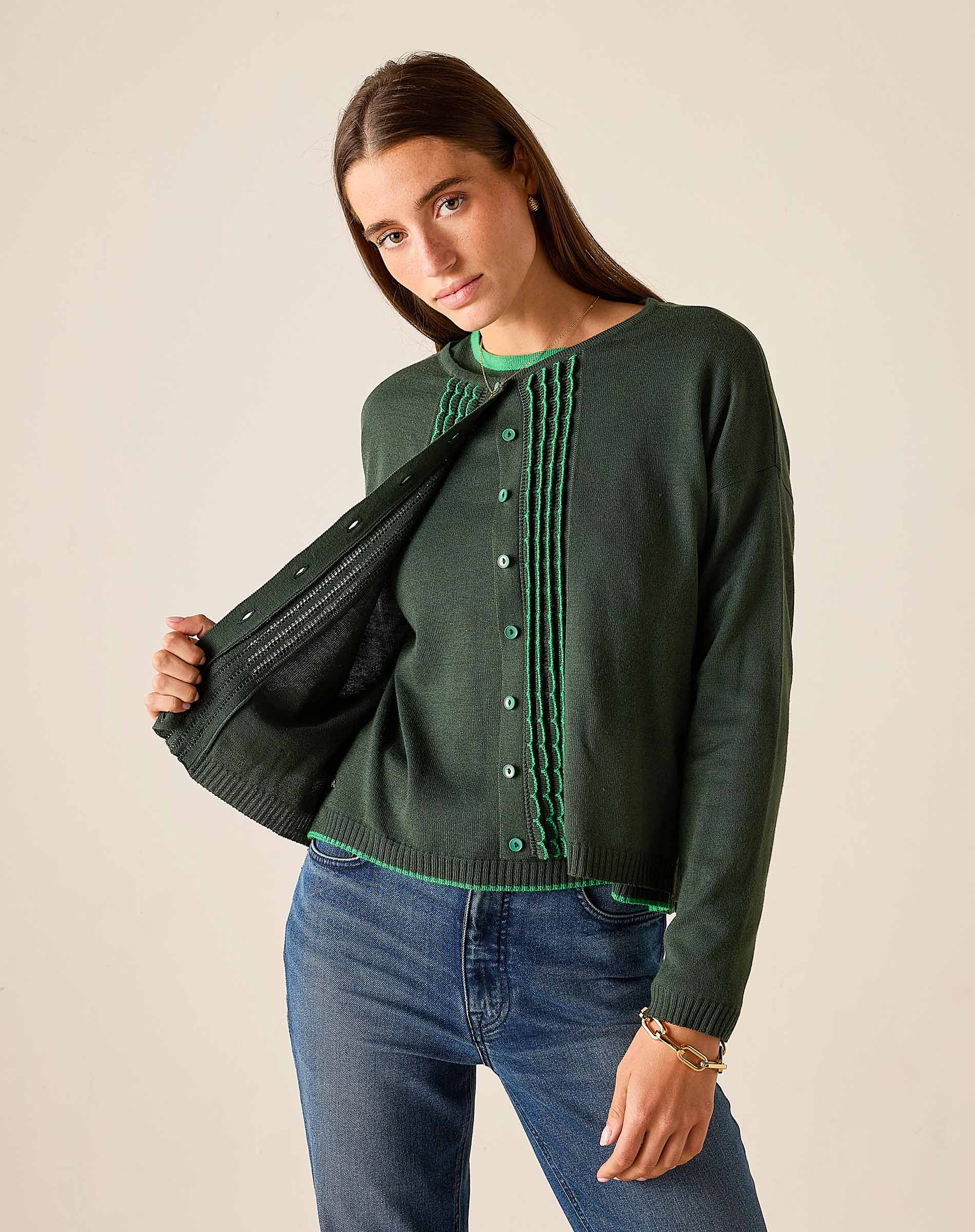 Pine green knit cardigan with ruffle detail and button front.