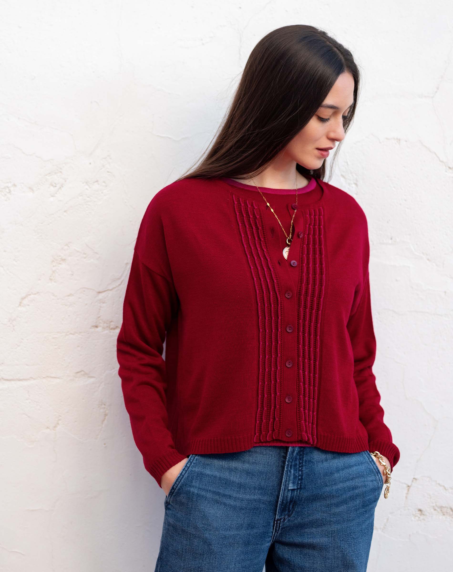 Wine red pleated knit cardigan with button front and ruffled trim.