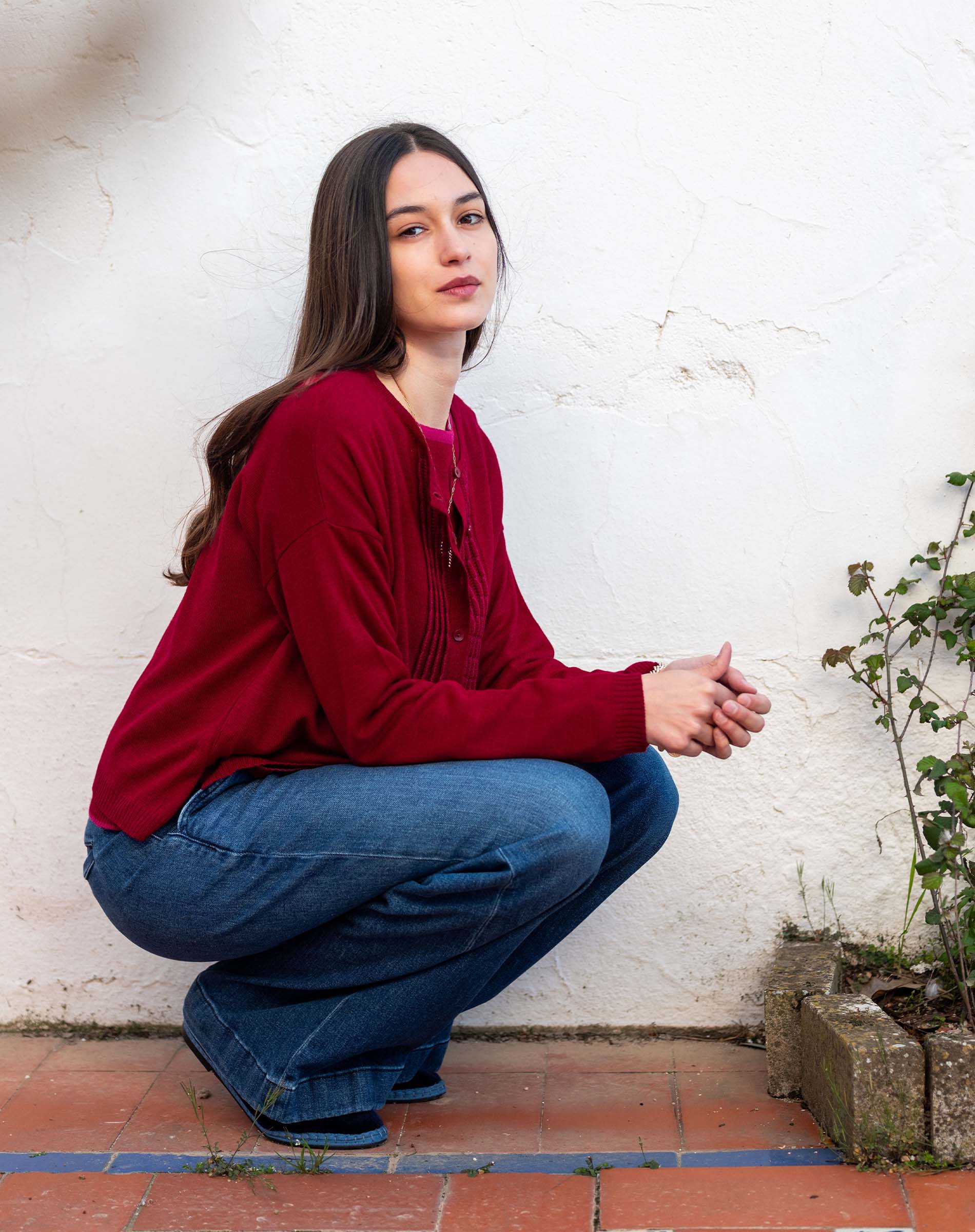 Wine colored ruffle cardigan knit top.
