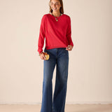 MERSEA ladies' travel-ready chili red knit sweater with long sleeves and a round neckline.