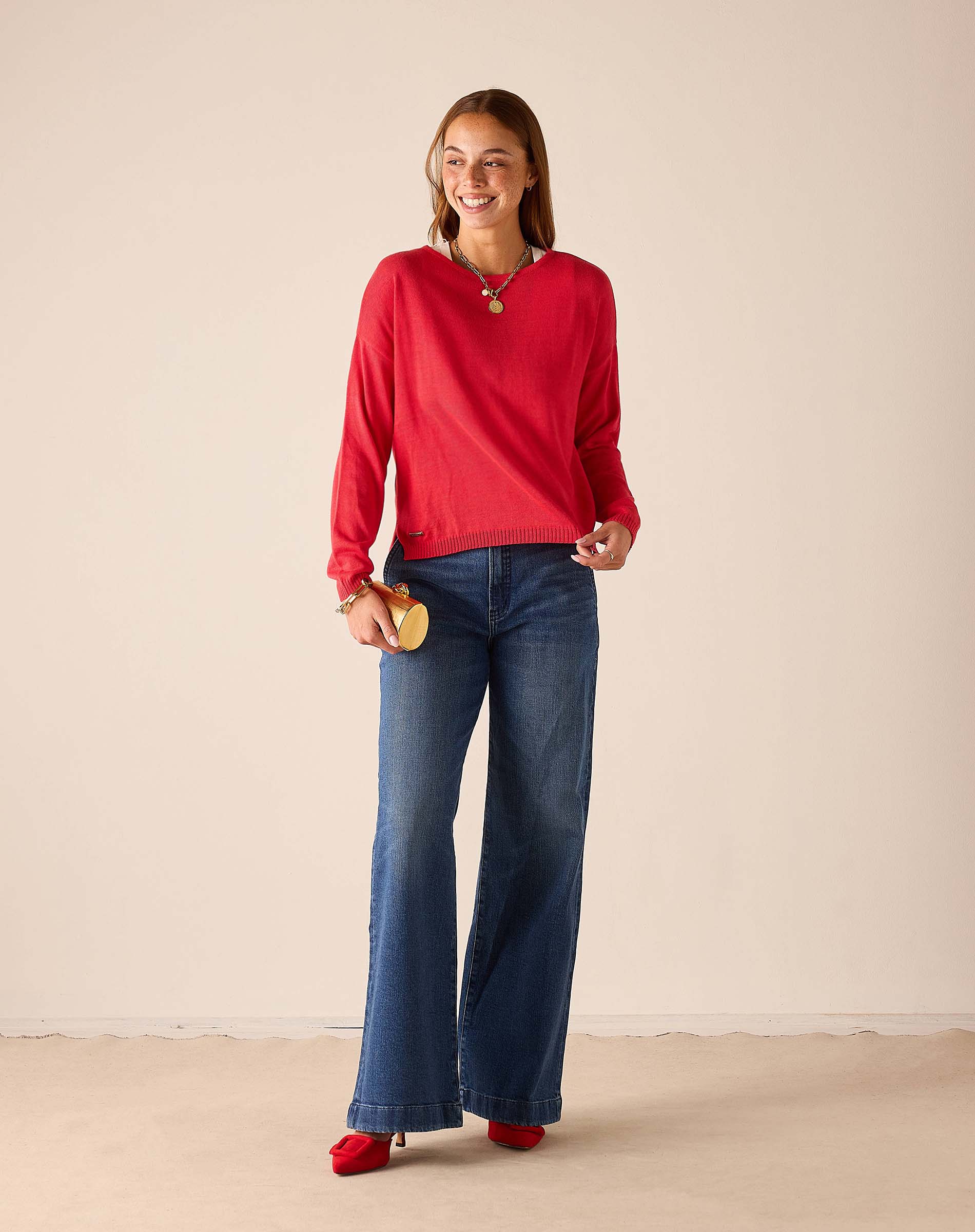 MERSEA ladies' travel-ready chili red knit sweater with long sleeves and a round neckline.