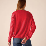 Back view of women's travel-friendly chili red knit sweater with a ribbed hem and cuffs.