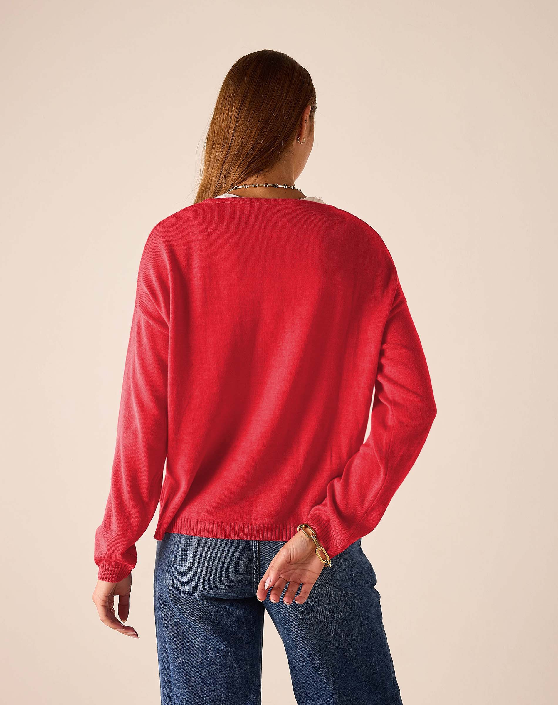 Back view of women's travel-friendly chili red knit sweater with a ribbed hem and cuffs.