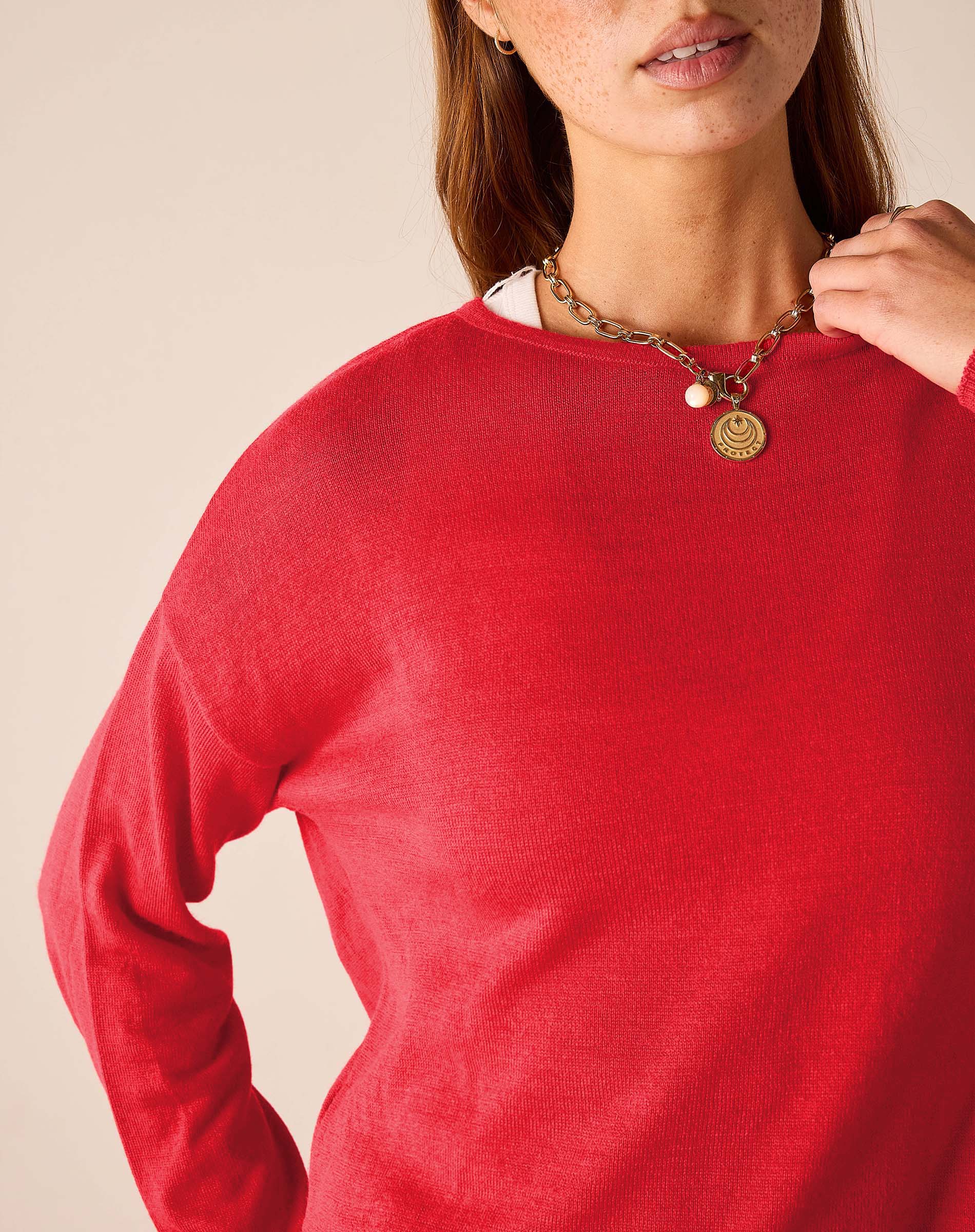Chili red knit sweater with a crew neck and long sleeves.
