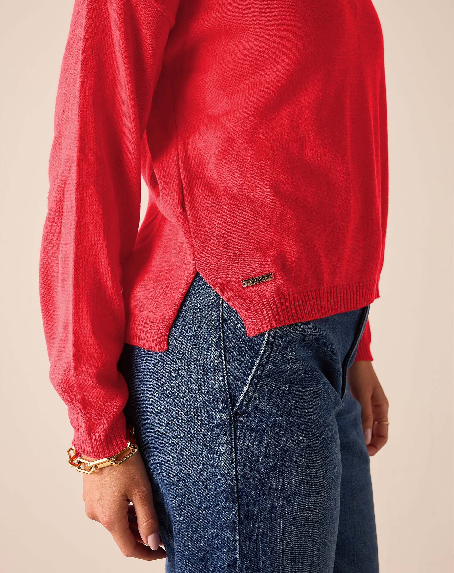 Chili red knit sweater with a ribbed hem and long sleeves.