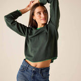 Pine green knit sweater with a cropped hem and long sleeves.