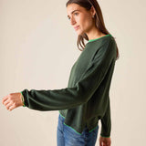Pine green knit sweater with lime trim on a model.